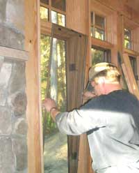 Worker installing screen on a window in the bug room